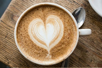 Cup of coffee with a heart shape in the foam