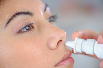 woman using nasal spray