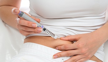 Woman injecting insulin