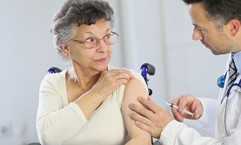 Healthcare provider giving woman vaccine