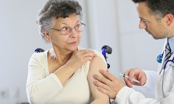 Healthcare provider giving woman vaccine