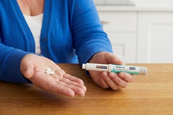 woman holding Wegovy tablets and injector